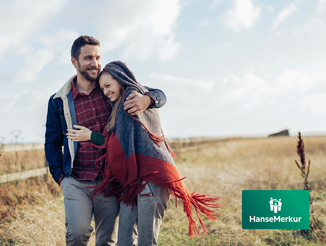 Ein PÃ¤rchen lÃ¤uft durch die DÃ¼nen. Buche jetzt den passenden Reiseschutz der HanseMerkur.
